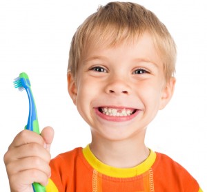 smiley boy without one teeth with toothbrush isolated on white background