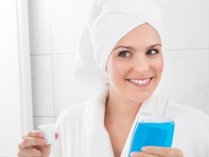 happy-woman-holding-bottle-mouthwash